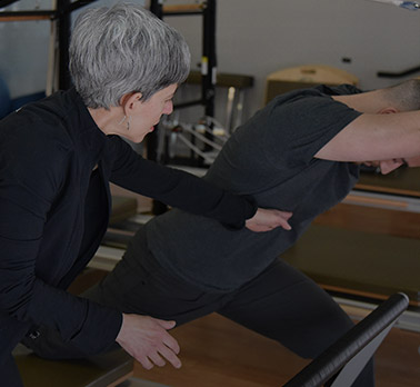 Senior Instructor Gayle in a Pilates Refomer Session